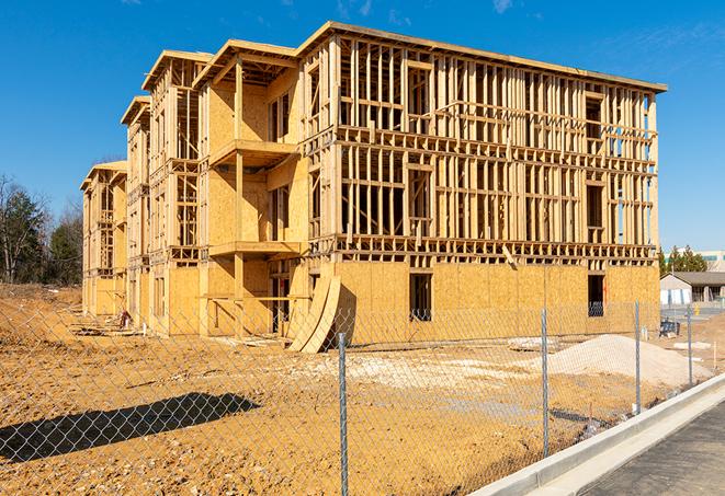 construction zone secured with a temporary fence, marked with warning signs in Mira Loma